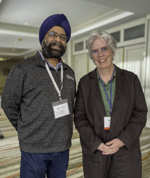 Inder Monga (ESnet) and Carol Hawk (U.S. Department of Energy) Photo: Two people standing in work attire, smiling at camera