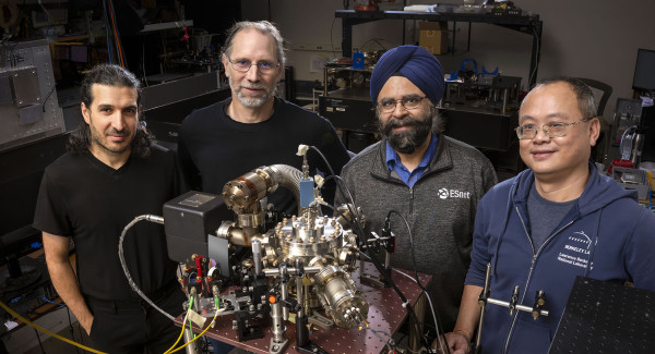 Four men with quantum networking equipment 