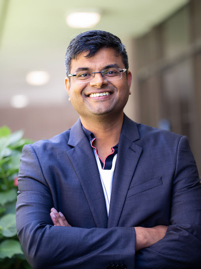 Arpit Gupta, in glasses with arms crossed