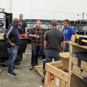 Men in a circle listening to instructions