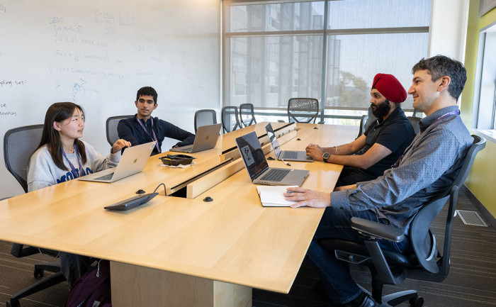 Students and mentors sitting around a table