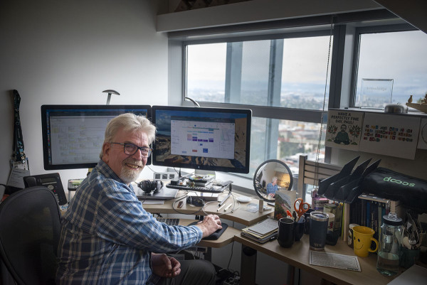 Man sitting at desk turning to camera